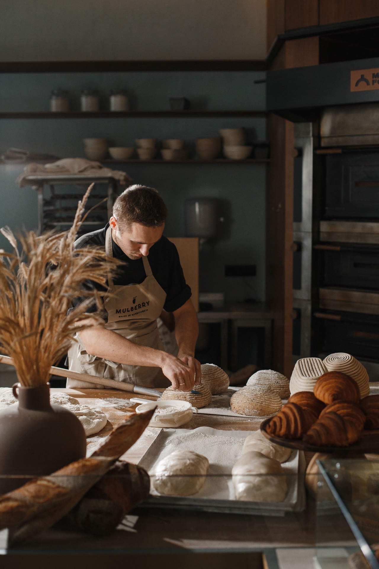 Baker shaping loaves at Mulberry